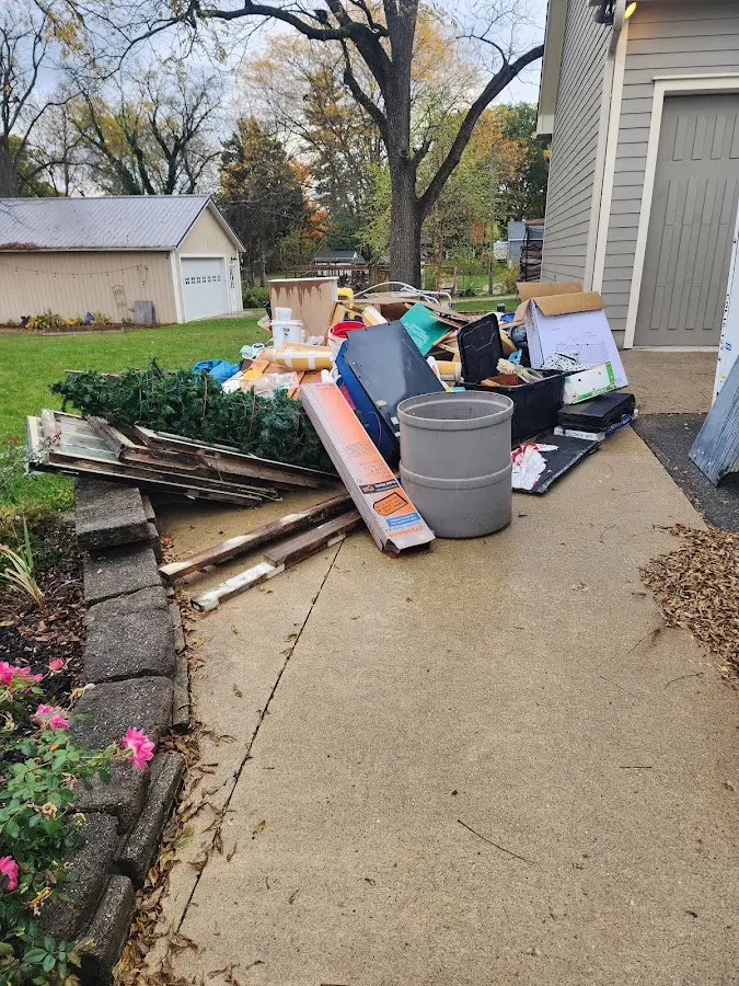 Dumpster being loaded with debris for Commercial Dumpster Rental in Cambridge